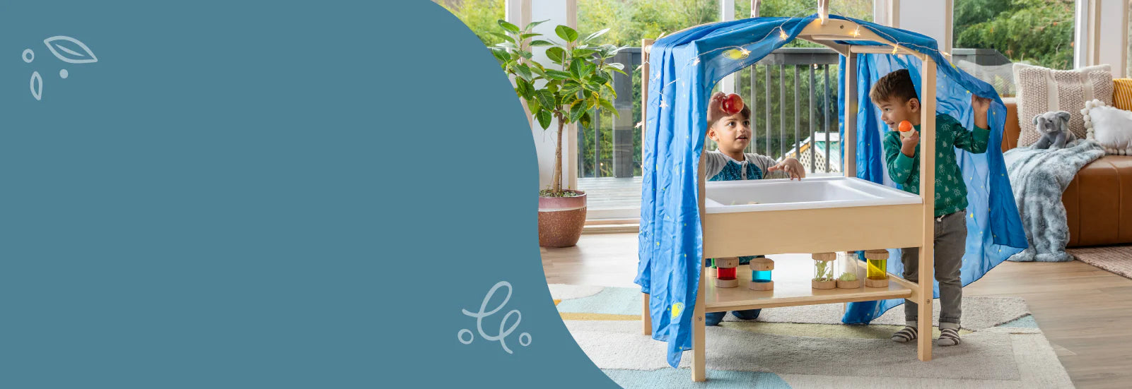 2 young boys playing with the sensory table