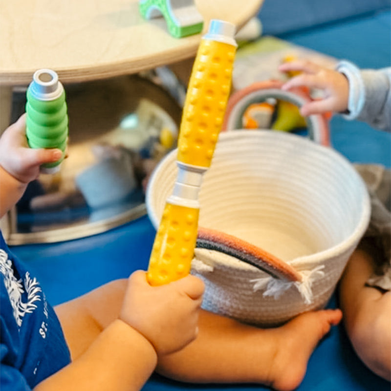 Toddler hand playing with Grippies® magnetic building toys