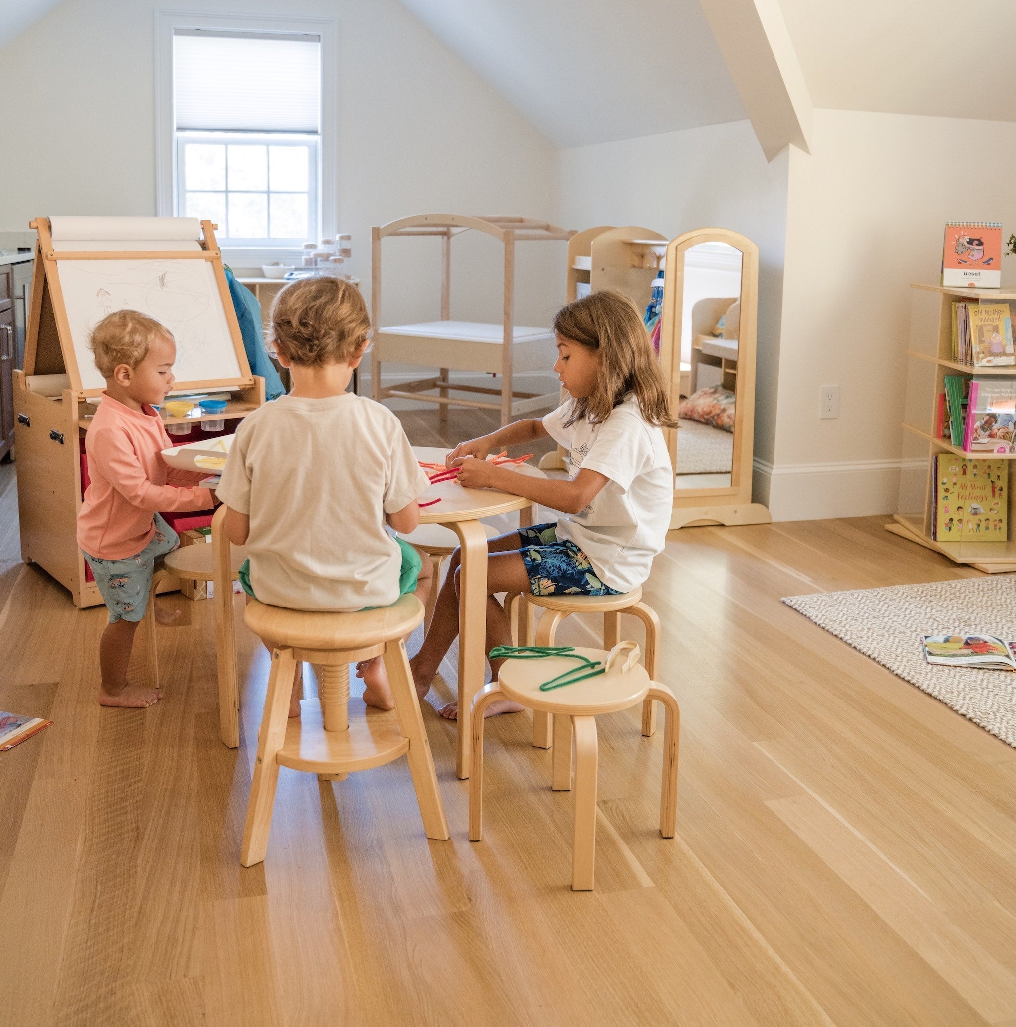 3 young boys using a table in their homeschool space 