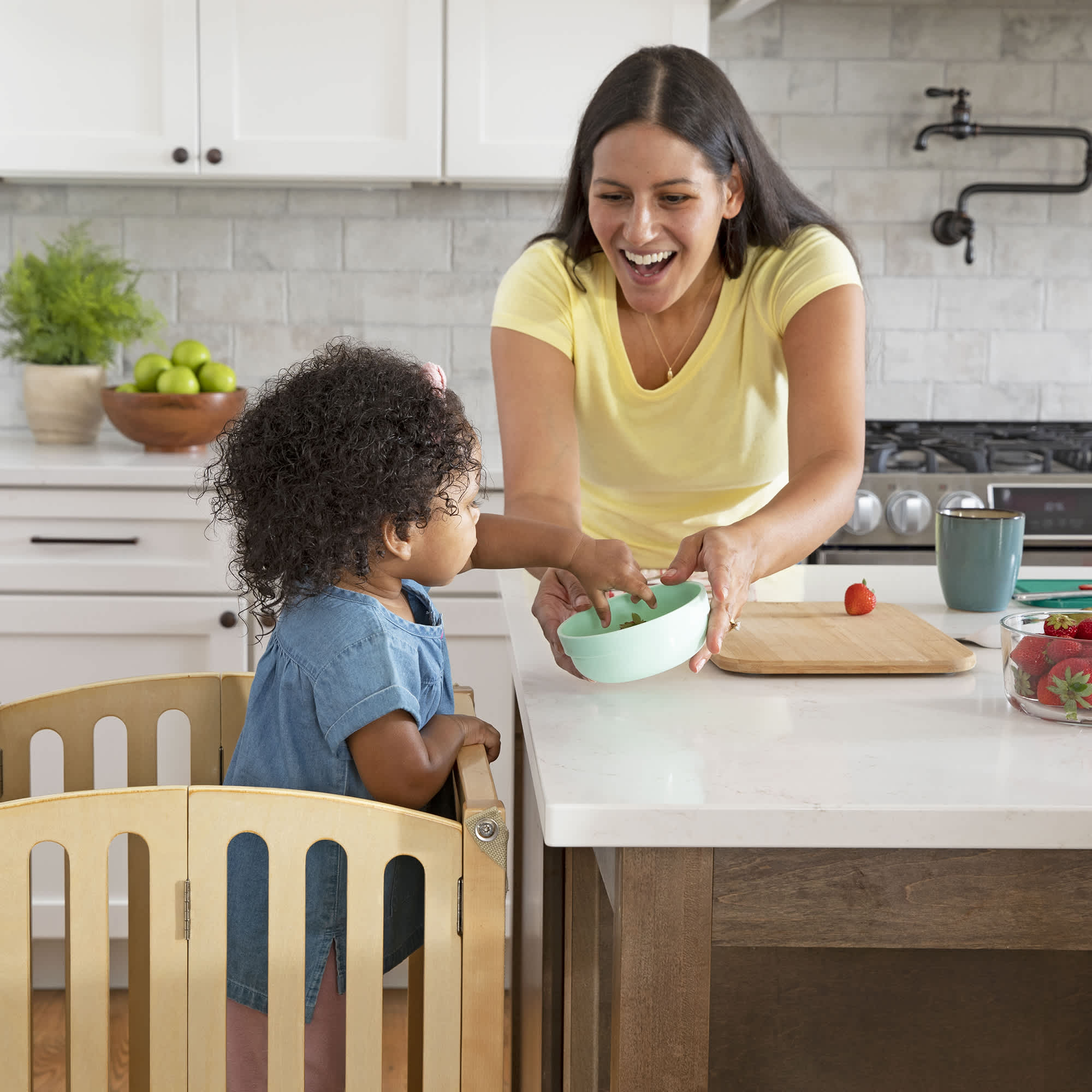 Mom and toddler daughter in the kitchen together enjoying a snack while the child is in a Contemporary Kitchen Helper