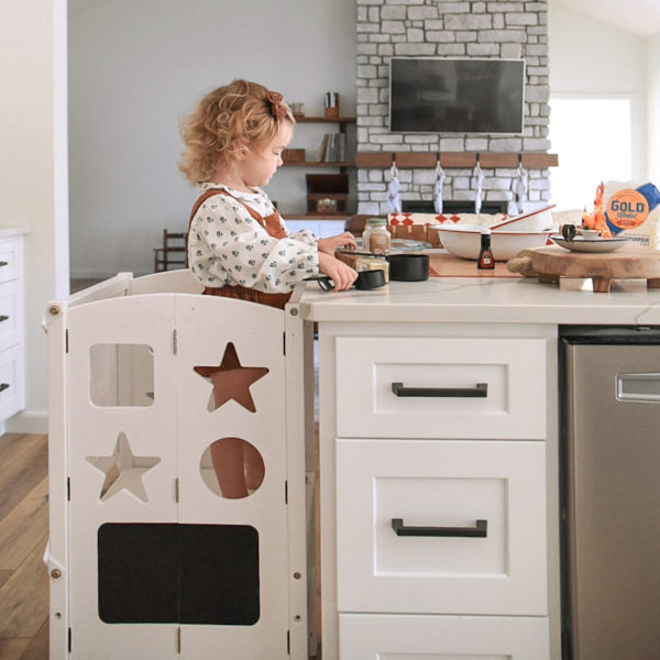 Image of toddler in Guidecraft Kitchen Helper Step Stool baking for the holidays