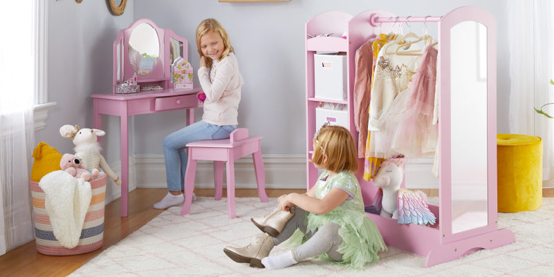 Two girls using the dress up storage and vanity