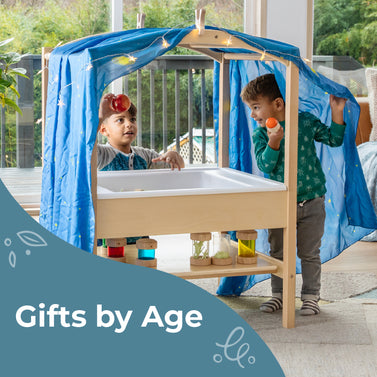 2 young boys playing with the sensory table