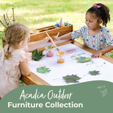Two children painting with outdoor items at an art table, with text about the Acadia Outdoor Collection. shop now button-click to shop the collection.