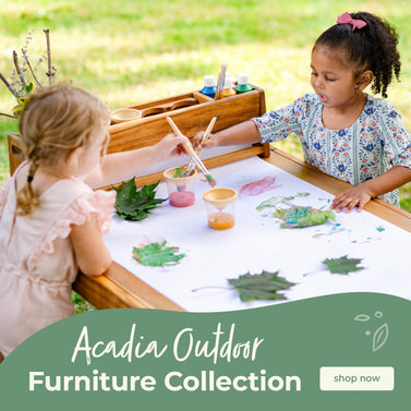 Two children painting with outdoor items at an art table, with text about the Acadia Outdoor Collection. shop now button-click to shop the collection.