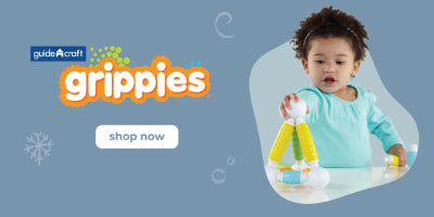 A young child explores creativity with colorful Guidecraft Grippies magnetic building toys. Text reads Guidecraft Grippies and shop now.