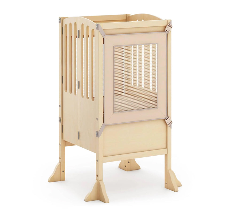 Modern white baby crib with mesh side panel and angled legs, featuring a sleek, Natural contemporary design