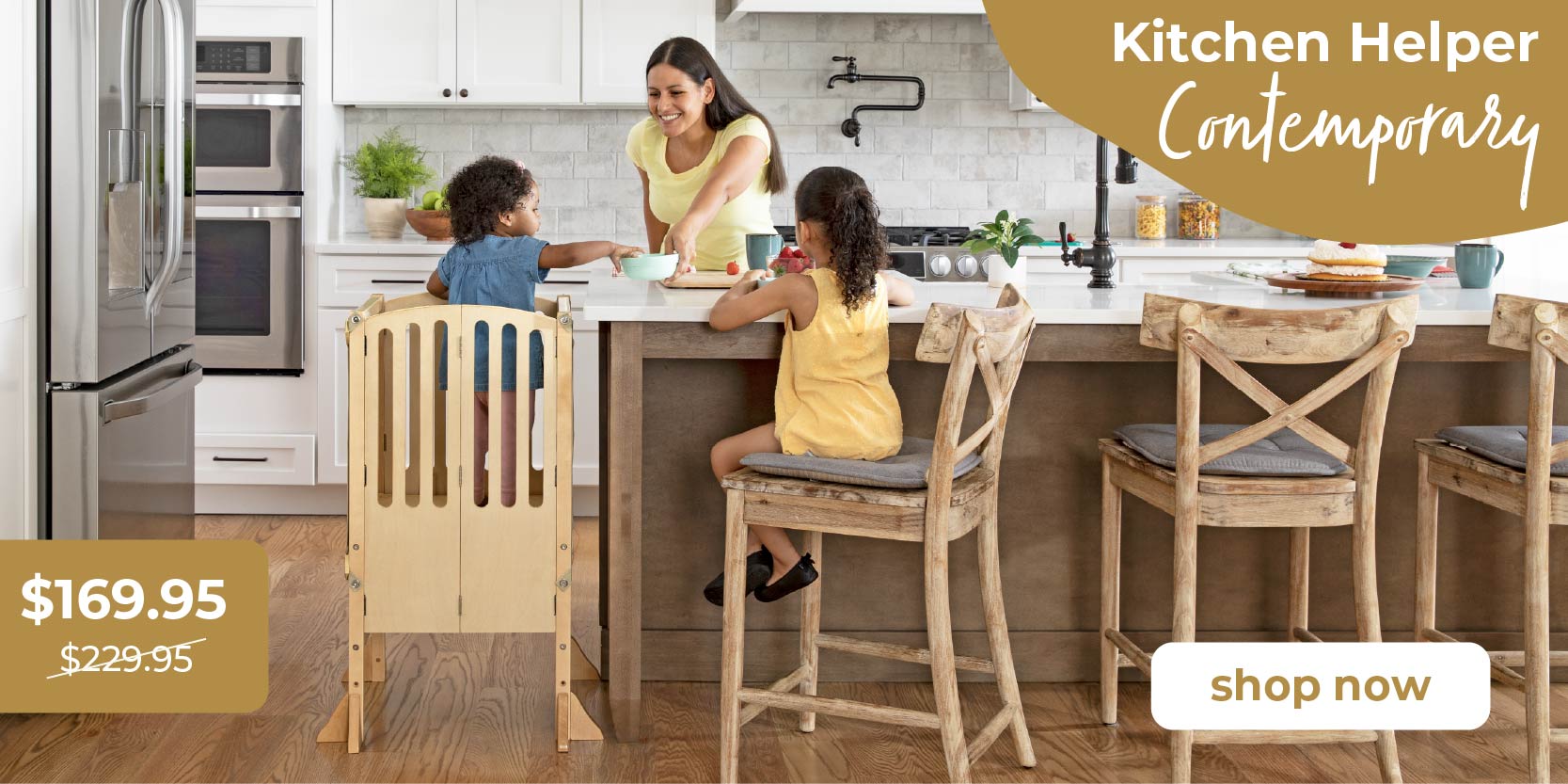 Family in a modern kitchen with wooden chairs and a promotional banner for 'Kitchen Helper Contemporary' toddler tower. Click to shop Kitchen Helper Contemporary.