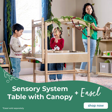 Children playing at a sensory system table with canopy and easel in a classroom setting.  Regular price $449.95, sale price $339.95. Click to shop the Sensory System and Easel attachment which is sold separately. 