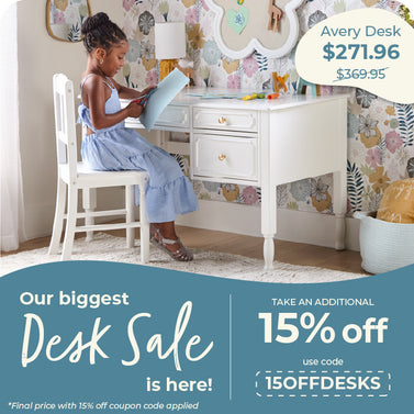 A child sits at a white writing desk in a decorated room with floral wallpaper, alongside sale text overlays for an Avery Desk.
