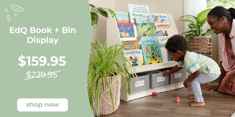 EdQ Book + Bin Display with children playing and a woman supervising, on a wooden floor with plants. Click to shop $70 off the book and bin display