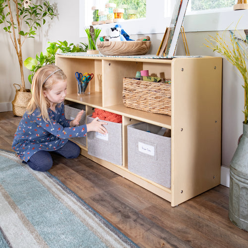 Young girl pulling out a fabric bin from the EdQ 5 Compartment Storage Shelf