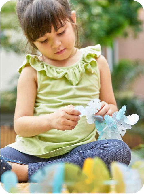 Child holding a toy in an outdoor setting