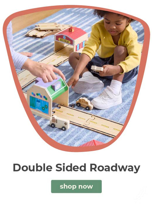 Child playing on rug with the double sided roadway. Click to shop The Double Sided Roadway