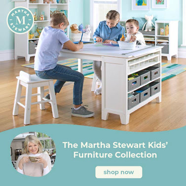 Children using a Martha Stewart Kids' Furniture Collection art table with stools in a home setting. Click to shop the collection.