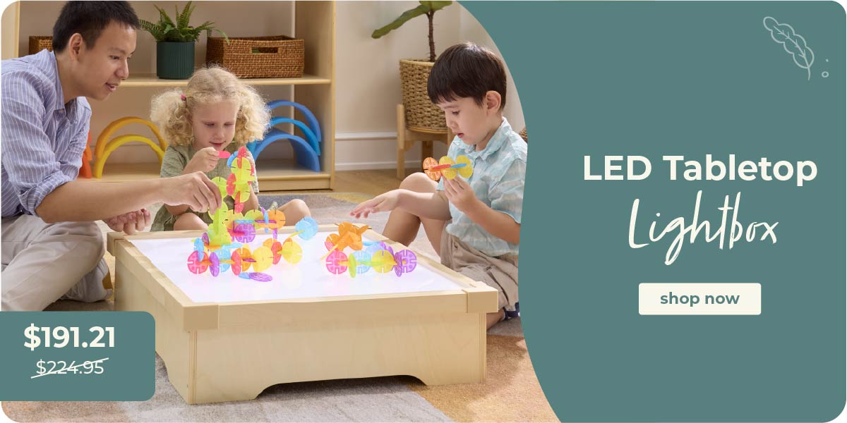 Children playing with colorful toys on a lightbox, with a father beside them. Ad for LED Tabletop Lightbox with price and 'shop now' button. Click to shop the Tabletop Lightbox at $191.21 down from $224.95.
