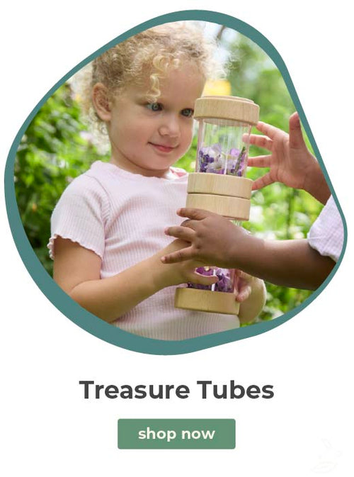Child holding a wooden treasure tube with text 'Treasure Tubes' and 'shop now' button. Click to shop treasure tubes.