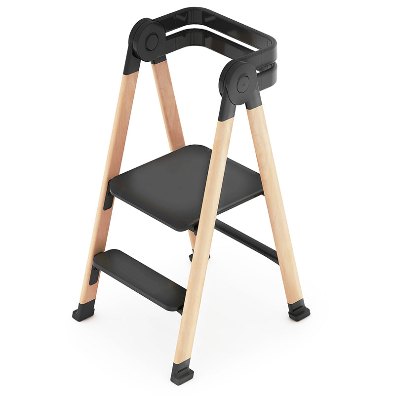 Step stool with black seat and wooden legs on a white background