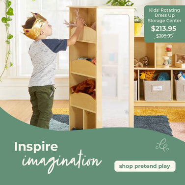 Child playing with a rotating dress-up storage center in a room with green walls and toys. Click to shop all pretend play furniture.