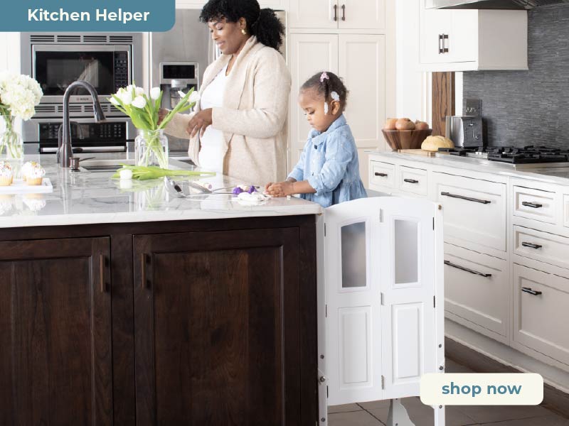 Woman and child in a kitchen with a Martha Stewart Kitchen Helper Toddler Tower. Click to shop all Martha Stewart Kitchen Helpers