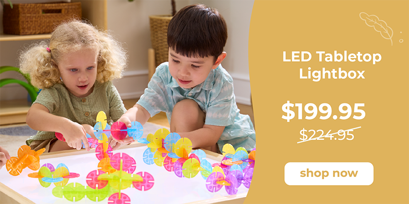 Two preschool aged children playing with colorful toys  called Interlox on a light table, with an LED tabletop lightbox advertisement on the right.