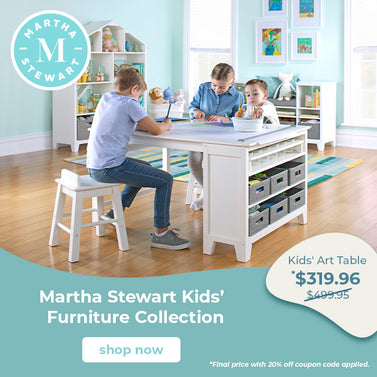 A white Martha Stewart Kids' Art Table shown in a bright children's room with three kids sitting around it, plus promotional text and a Martha Stewart logo.
