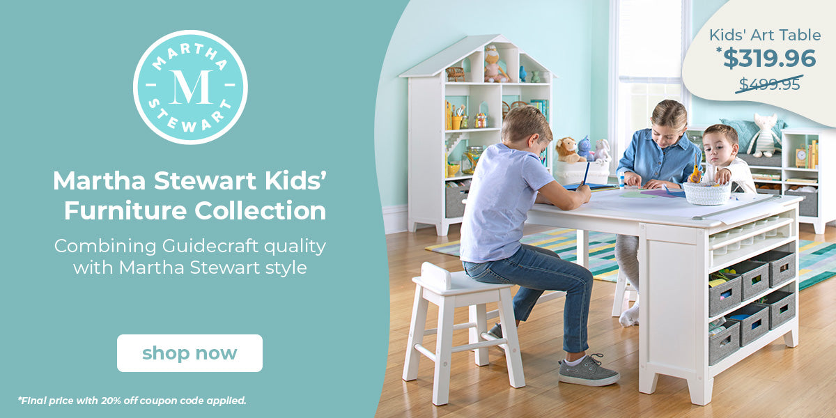 A children's activity table in a bright room, with two adults and a child sitting at the table. The scene is split with a large teal graphic on the left featuring the Martha Stewart logo and text for the Kids' Furniture Collection, plus a price callout for the Kids' Art Table.