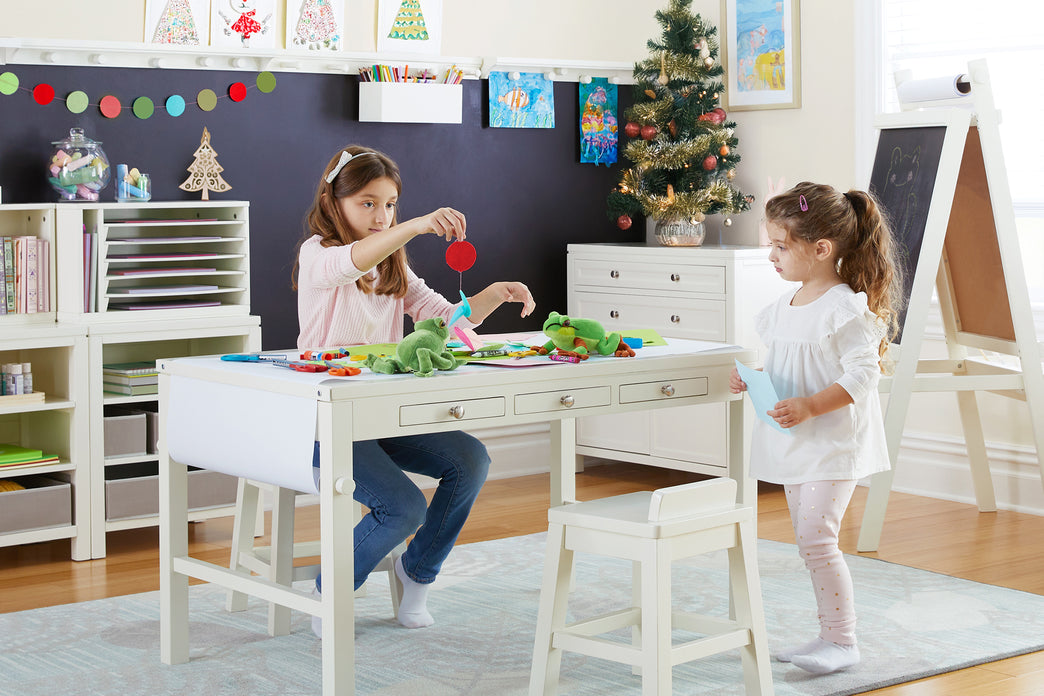 Two children are doing crafts at a Martha Stewart Art table in a classroom setting. Click to shop all art tables.