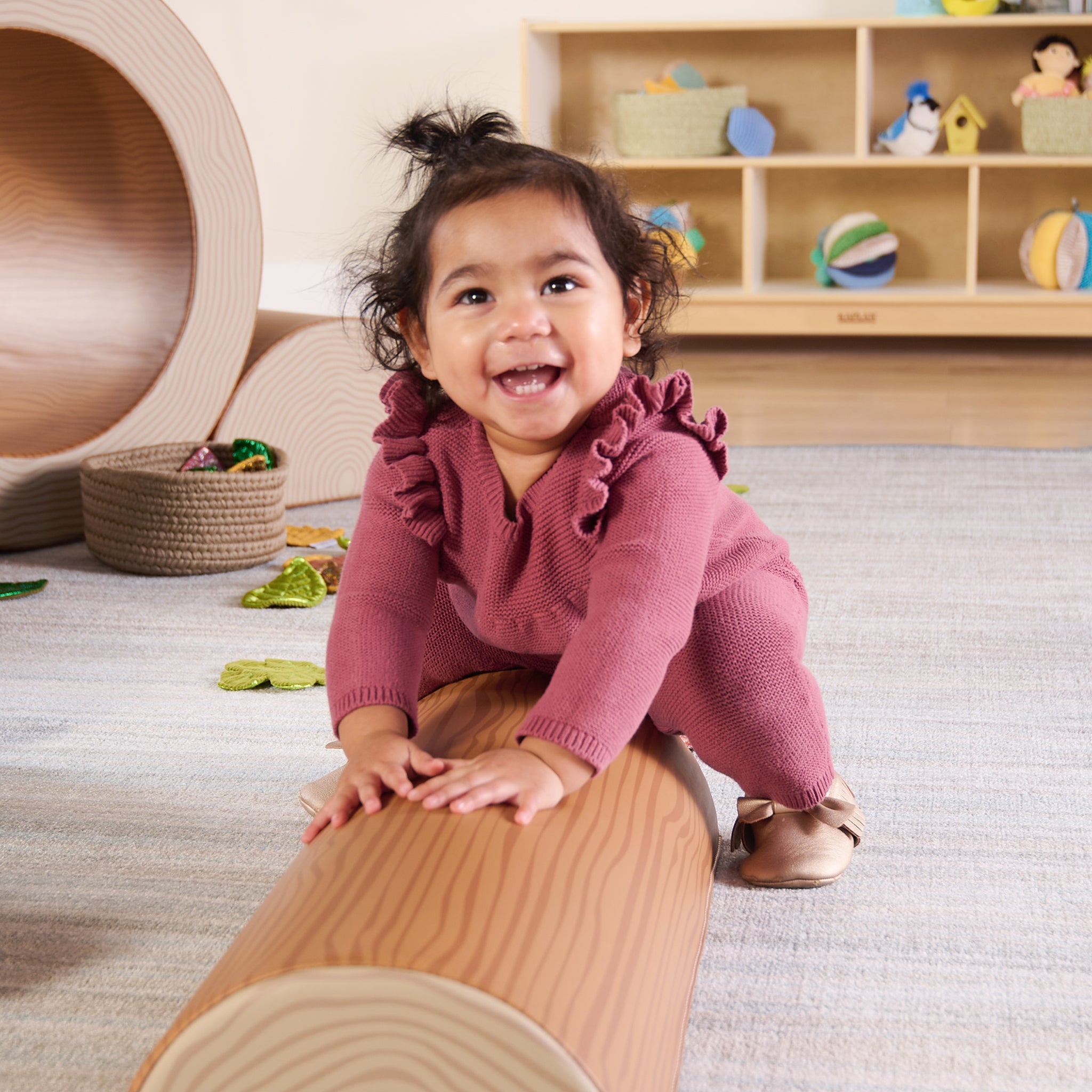 Child playing with a wooden toy in a nursery setting