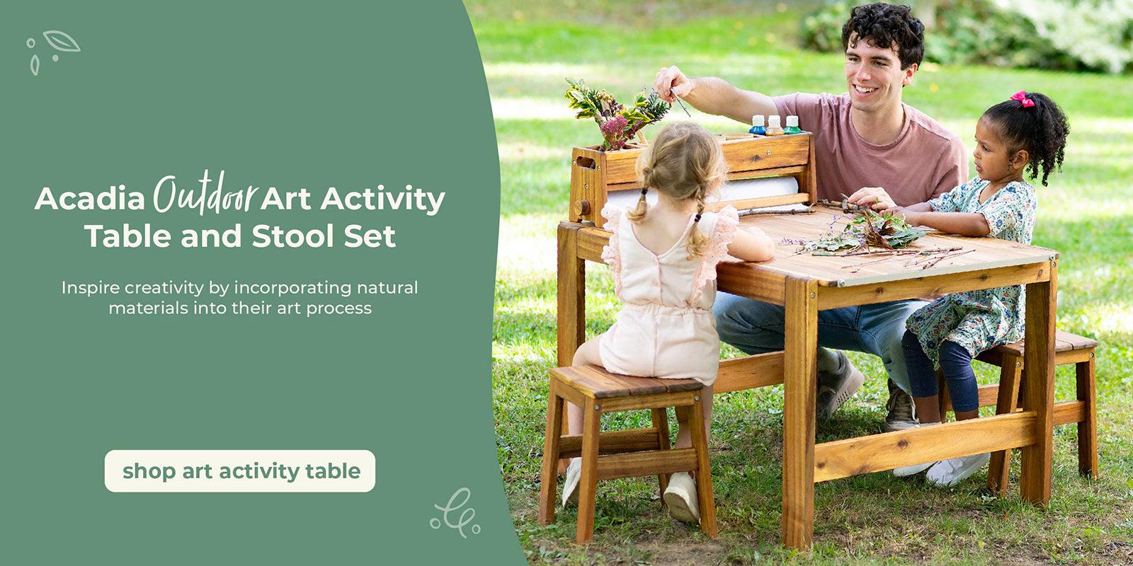 Two children and a adult sitting at an outdoor art activity table in a grassy area. Creating art on the Acadia Art Activity Table. Click to shop the art table.