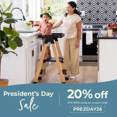 Woman and child using a kitchen helper stand with a President's Day sale advertisement. Use code PREZDAY26 to save an additional 20% off.