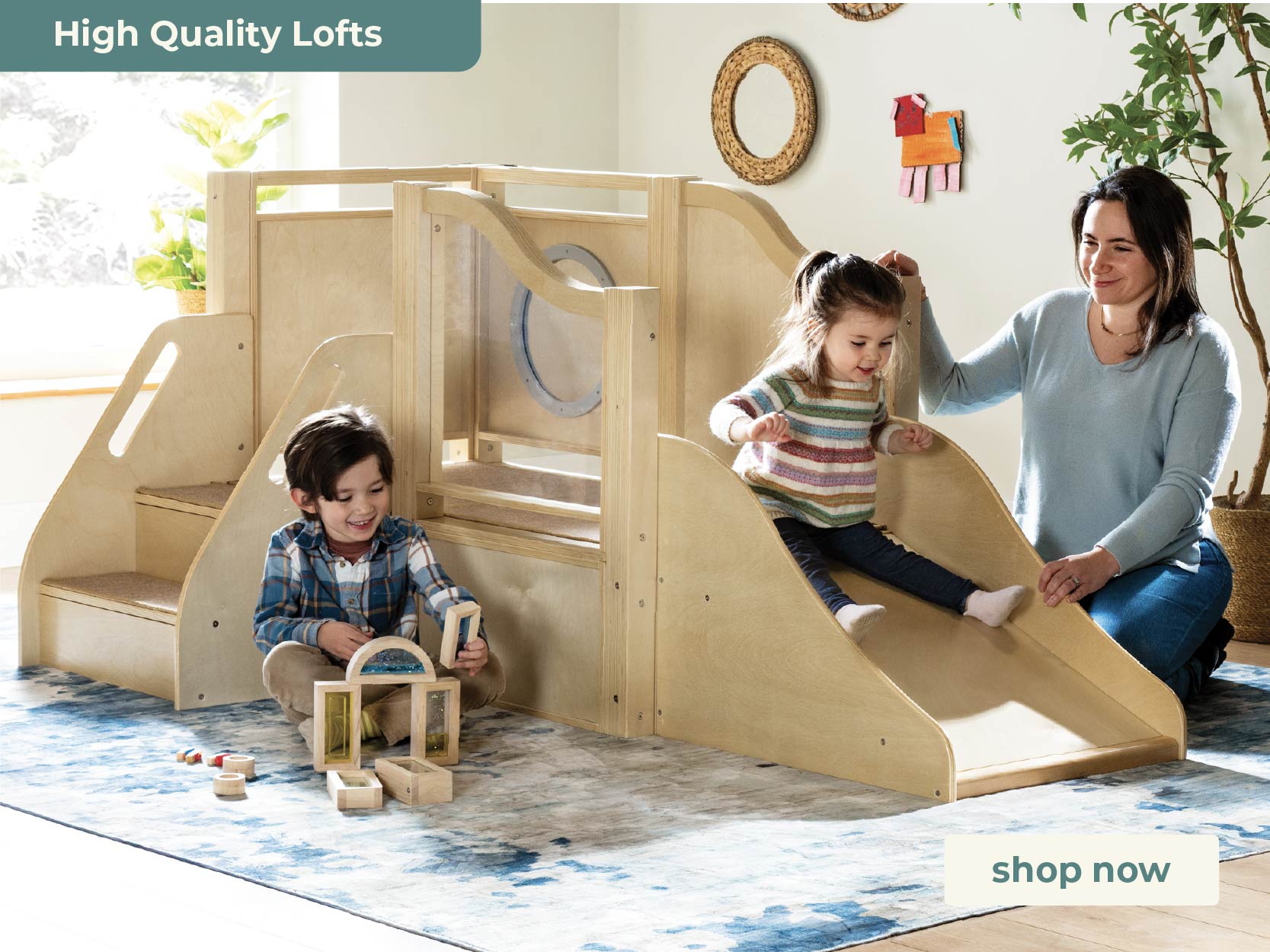 Children playing on a wooden loft bed with slide and toy storage, with a woman supervising.
