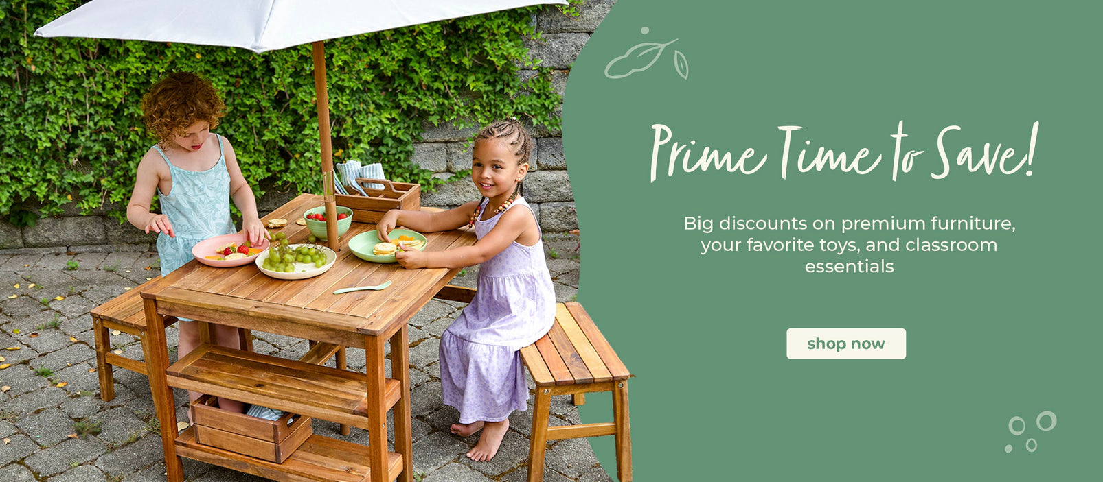 Two girls sitting at the Martha Stewart Crafting Table, click to shop all outdoor furniture