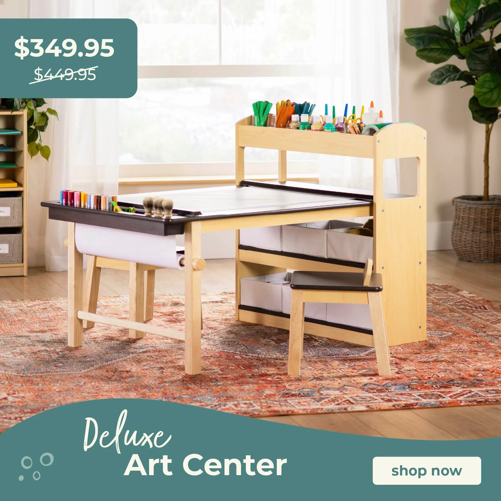 Wooden art center with table and stools in a room setting, promotional text overlay. Click to shop the Deluxe Art Center