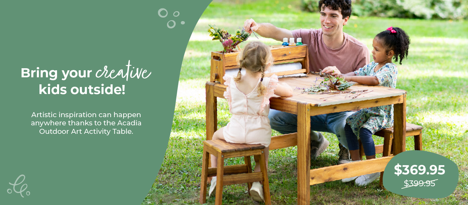 Family with children at a wooden outdoor art activity table in a park, click to shop $30 off the Acadia Outdoor Art and Activity Table.