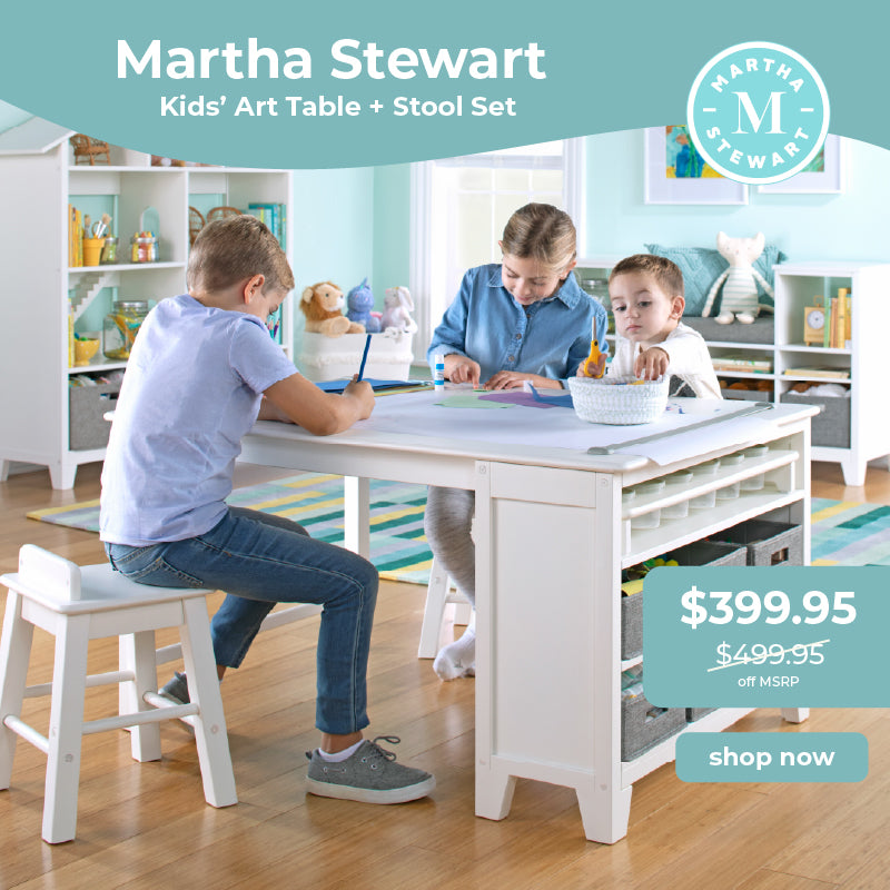 Martha Stewart Kids' Art Table and Stool Set with children using the table, on a light blue background. Click to shop $100 off.