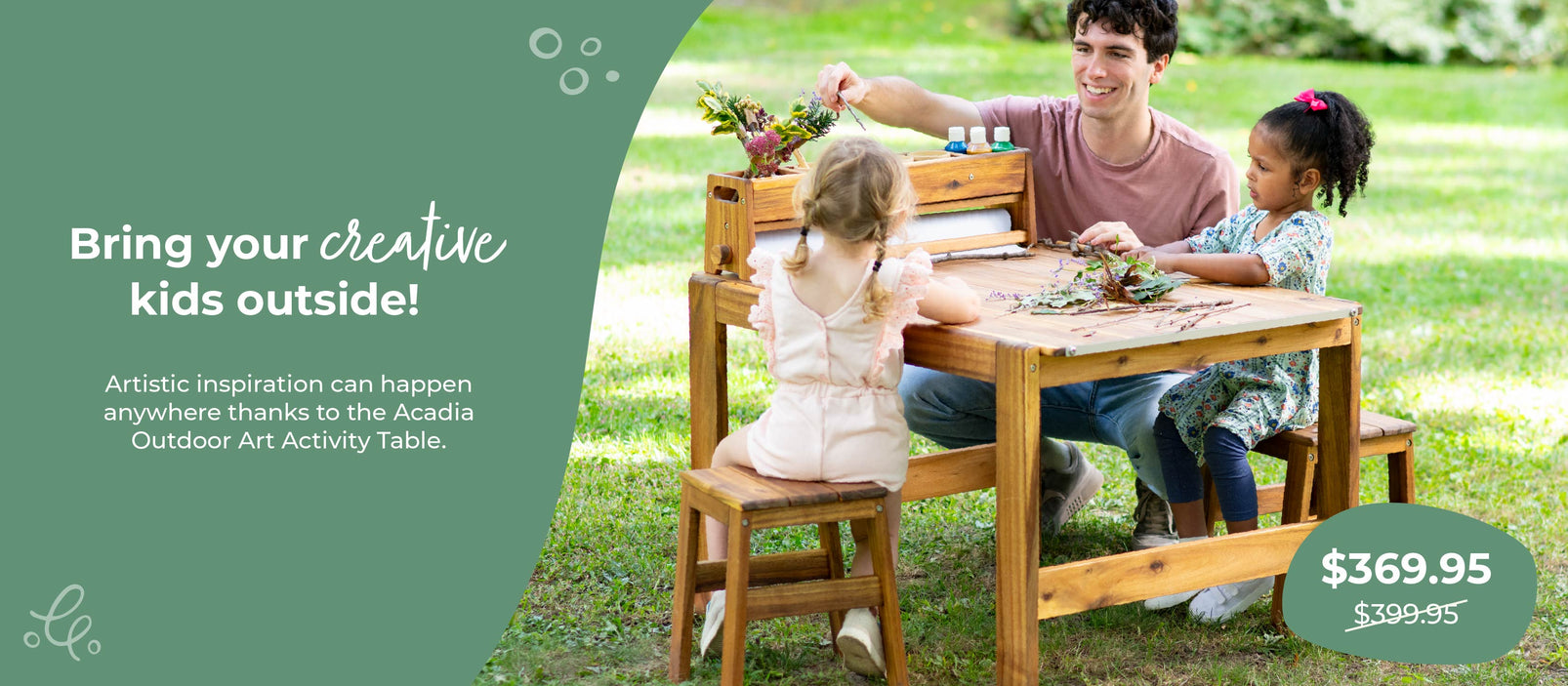 Family with children at a wooden outdoor art activity table in a park, click to shop $30 off the Acadia Outdoor Art and Activity Table.