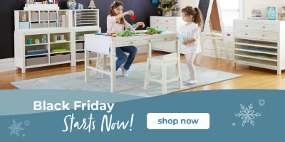 Children playing at a white table with chairs in a room, promotional banner for Black Friday sale.