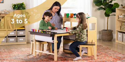 Woman and two children at a wooden table with art supplies in a home setting.