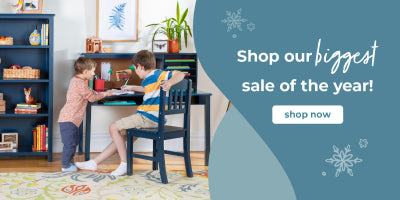 Two children at a table with books and a plant, promotional text for a sale on a blue and green background.